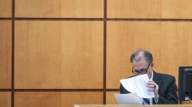 Pierce County Sheriff Ed Troyer reads through a police report written by Tacoma Police Department Det. Chad Lawless after his encounter with newspaper carrier Sedrick Altheimer on Jan. 27, 2021 in his north Tacoma neighborhood. Sheriff Troyer took the witness stand on Thursday, Dec. 8, 2022, in Pierce County District Court in Tacoma, Wash.