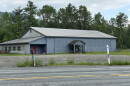 A gray building by a road