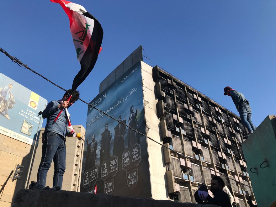 Protesters near Baghdad's Khilani Square, where security forces have opened fire on demonstrators trying to block roads.