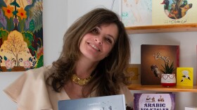 Rafa Saab poses with a children’s book written in Arabic. Saab co-owns ArabiKids, a subscription-based company that sends children’s books written in Arabic.