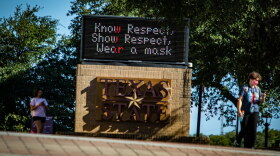  Students wear masks on the campus of Texas State University last fall. 