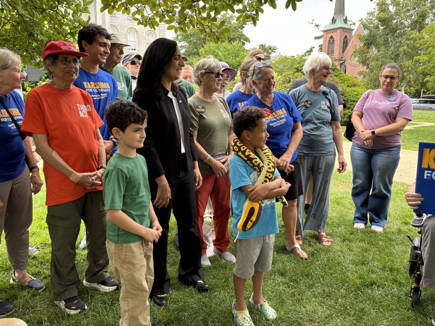 Karishma Manzur (in black) gathers with supporters at the State House, July 31, 2026.