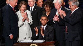 U.S. President Barack Obama signs the Dodd-Frank Wall Street Reform and Consumer Protection Act.