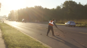 road worker filling in a pothole
