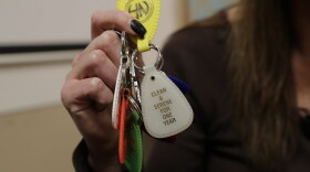 A person holds key fobs that mark her days of sobriety and recovery from using drugs. (Ted S. Warren/AP)