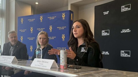 Haley DeGreve, founder and CEO of The Gray Matters Collective, speaks at a mental health roundtable Thursday, April 2 in Moline, as U.S. Rep. Eric Sorensen and Michelle Schwarz listen.