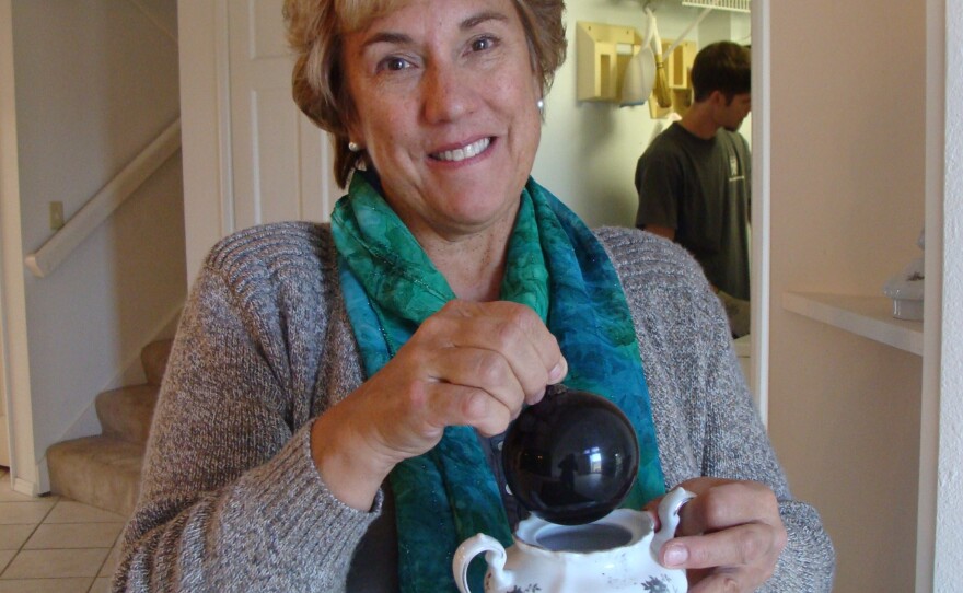 Janet Wilson salvaged a few things from the ashes of her former house, including her mother's sugar bowl and a single, fire-scorched Christmas ornament.