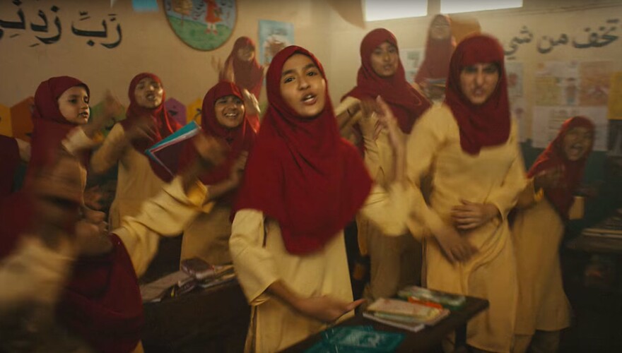 One scene from the video is set in a school, with the girl students wearing hijabs.