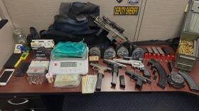 Drugs, weapons, and cash seized in apartment search.