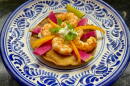 Shrimp tostadas with lime-cilantro cream, radishes, and peppers. (Kathy Gunst/Here & Now)