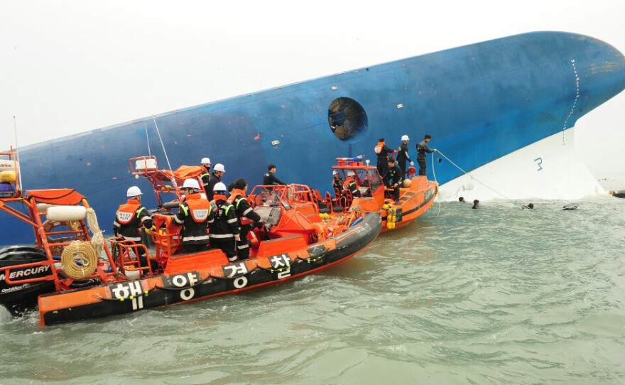 Members of South Korea's coast guard search for survivors.