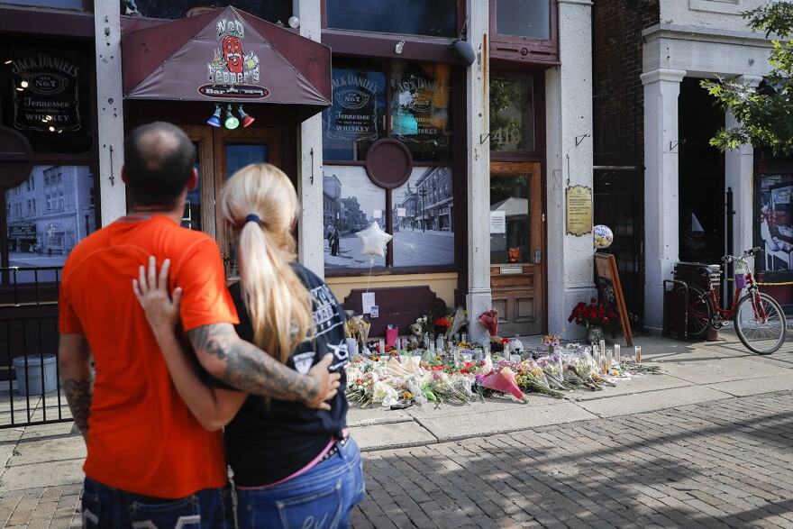 Mourners gather at a makeshift memorial outside Ned Peppers Bar in Dayton, Ohio, on Aug. 6, 2019, two days after a gunman killed nine people and wounded over two dozen others.