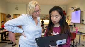 Paula Fortuna, a world literature teacher at the Center for Global Studies magnet program at Brien McMahon High School in Norwalk, CT helps one of her students in class