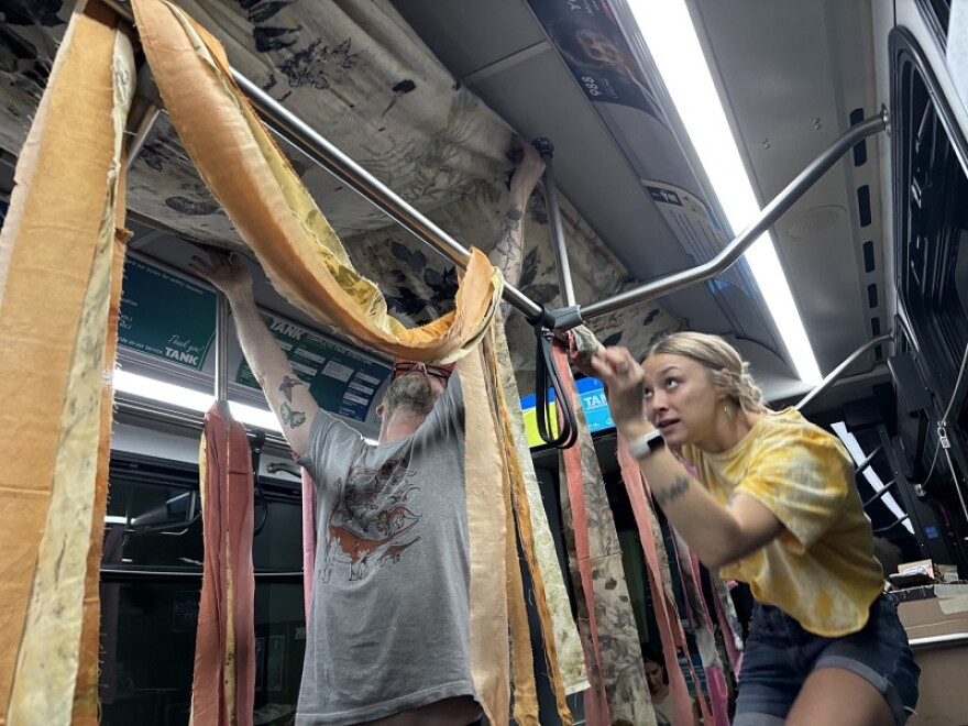 Artists Devan Horton and Ethan Machell collaborated on an environmental theme for the installation art. The final product felt like a rainbow . They also had packets of wildflower seeds for passengers to take home.