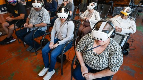 People use Meta Quest virtual reality headsets to experience life in Venezuela , Wednesday, October. 9, 2025, at Jumping Jackalope Axe Throwing. A man named Noa traveled to Venezuela after being warned it was not safe. After having a positive experience, he decided to stay for six months, filming his experencesl through a 360 camera. The film is now doing a U.S. tour showing people his experience through videos he captured.