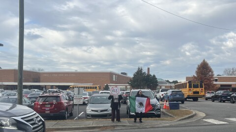 Community volunteers stand outside Jordan High School in Durham on November 19, 2025. The volunteers are there to help welcome students and to provide lookout for immigration agents.