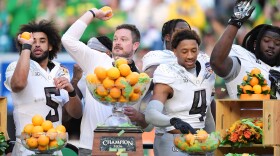 Oregon head coach Dan Lanning, second left, celebrates with quarterback Dante Moore (5), defensive back Brandon Finney Jr. (4), and defensive lineman Bear Alexander after defeating Texas Tech in the Orange Bowl College Football Playoff quarterfinal game, Thursday, Jan. 1, 2026, in Miami Gardens, Fla. 