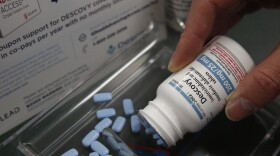 Pharmacist Clint Hopkins displays the HIV prevention drug Descovy, at Pucci's Pharmacy in Sacramento, Calif., Monday, Oct. 7, 2019.