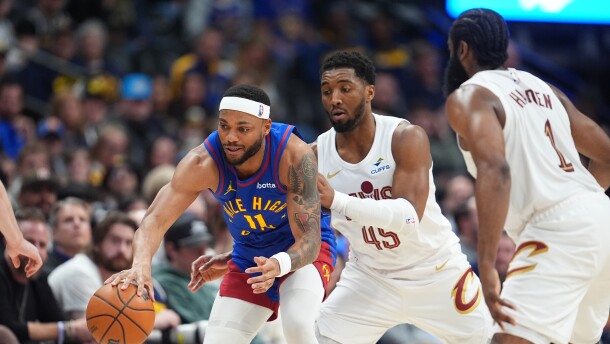 Denver Nuggets guard Bruce Brown, left, collects a loose ball as Cleveland Cavaliers guards Donovan Mitchell, center, and James Harden defend in the second half of an NBA basketball game, Monday, Feb. 9, 2026, in Denver. 