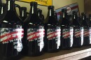 Finally legal to fill, 64 ounce growlers line the walls.