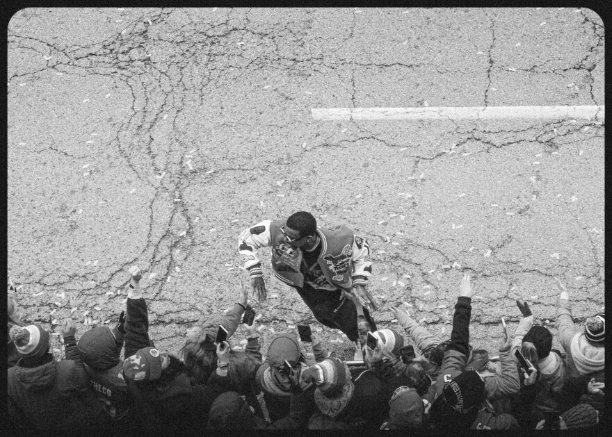 A Kansas City Chiefs player greets fans on Grand Boulevard during the Super Bowl victory parade on Feb. 15, 2023.