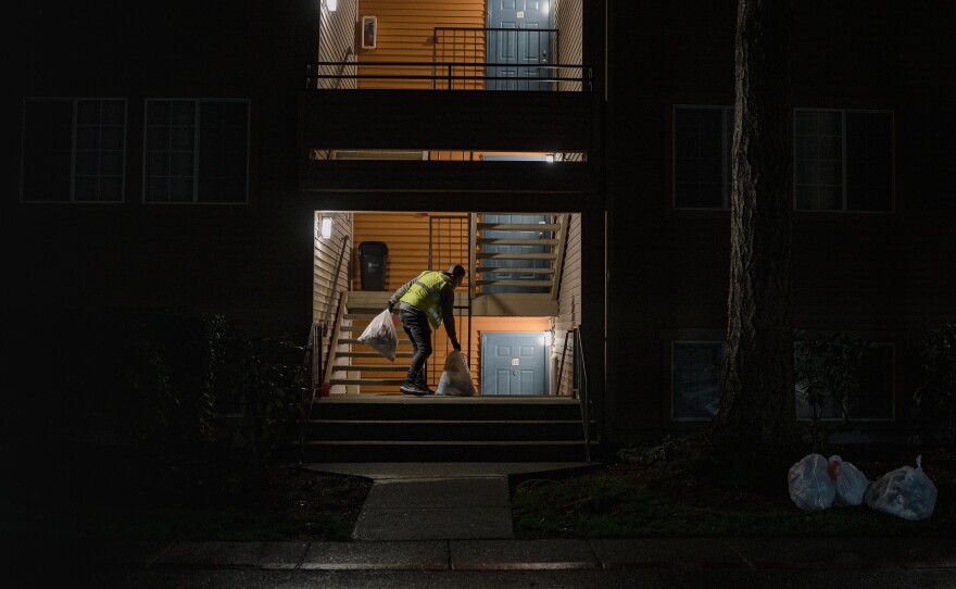 Riley Borup collects garbage bags at an apartment complex in Lynnwood, Wash. Frustrated by distance learning, Borup dropped out of his engineering program at Everett Community College to take a job as a trash collector.