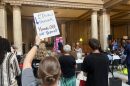 protestors holding signs against redistricting in the Indiana statehouse atrium