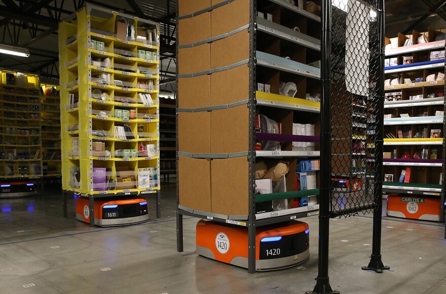 Kiva robots move racks of merchandise at an Amazon fulfillment center in Tracy, Calif., in 2015. The machines bring the shelves to workers.
