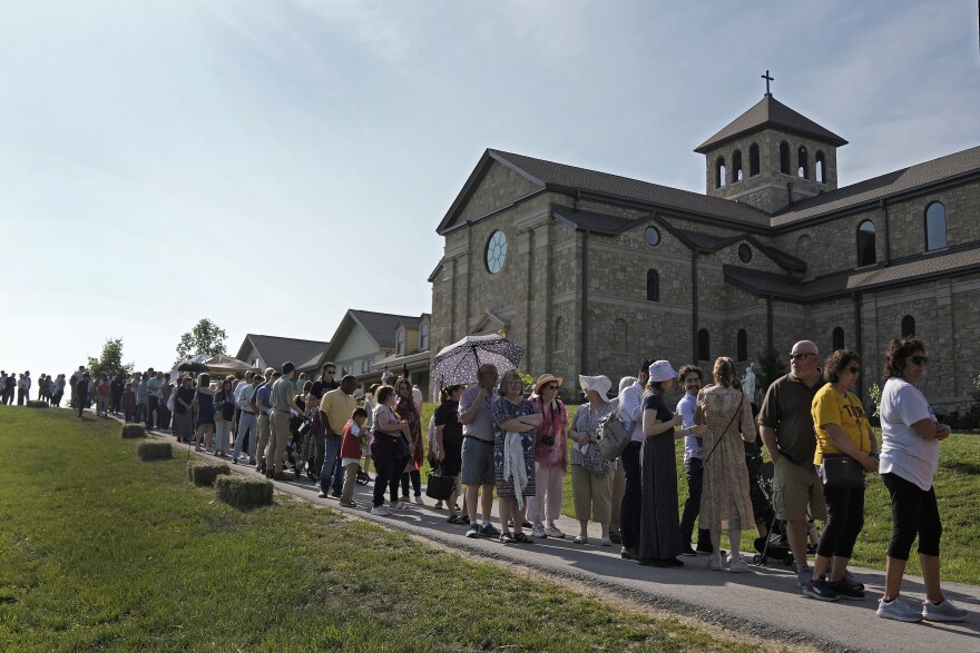  A long line of people outside a church.