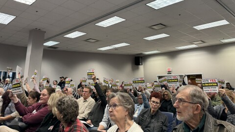 The Champaign County Community Center Auditorium was overflowing Tuesday night. Some residents pictured held signs saying "Vote yes for moratorium"