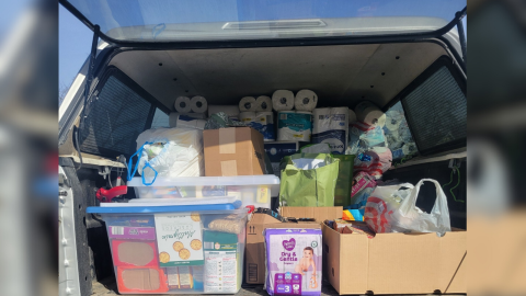 A truck is loaded with paper supplies like diapers and toilet paper as well as non-perishable food items to deliver to those in need.