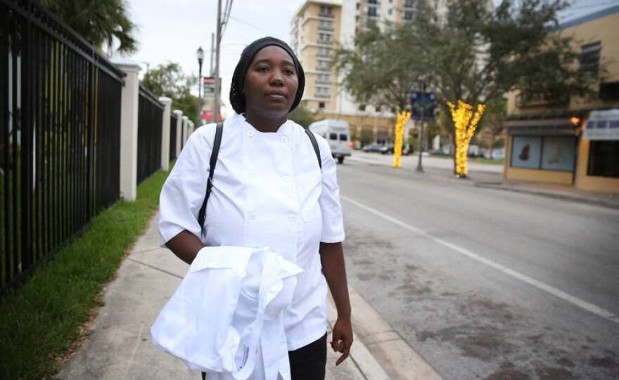 Michelle Phillips walks through her Overtown neighborhood on her way to one of her final days of classes at the Hospitality Education Advancement Training center at the Overtown Performing Arts Center kitchen. 
