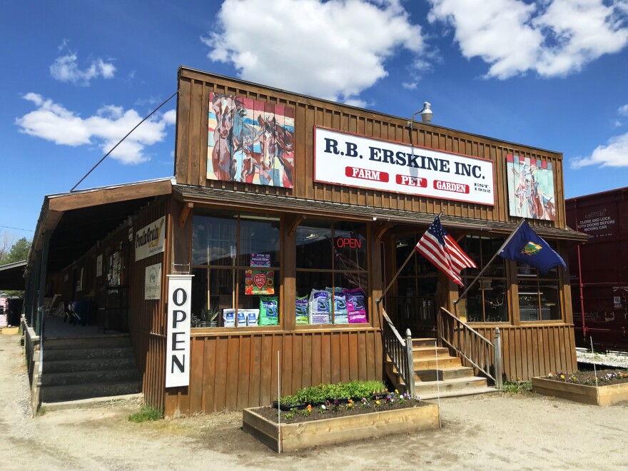 A wood-paneled store front against a blue sky