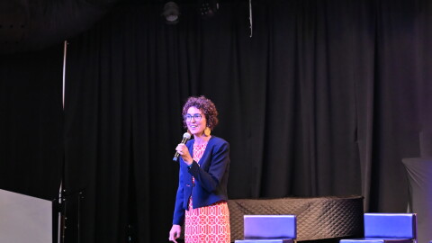 University of Tulsa professor of economics Clara Mattei stands on stage to speak to Tulsa residents during a forum organized by the Forum for Real Economic Emancipation.