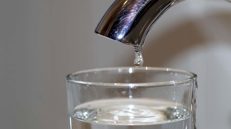 Water Faucet dripping water in glass