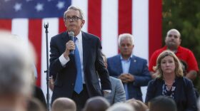 Ohio Gov. Mike DeWine, left, speaks alongside Dayton Mayor Nan Whaley, right, during a vigil at the scene of a mass shooting, Aug. 4, 2019, in Dayton, Ohio. (John Minchillo/AP)