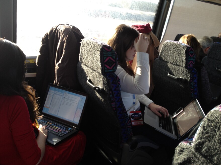 Perry press corps huddles over their computers scrambling to find a flight to South Carolina.