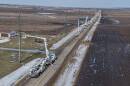 On a sunny winter day and a little snow on the ground, Ameren Illinois customers can be seen from a drone working on a electrical lines just off a rural road. 