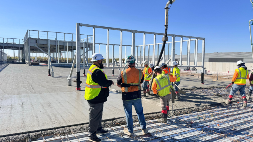 Union laborers pour and finish a concrete deck on a Kansas City-area construction site.