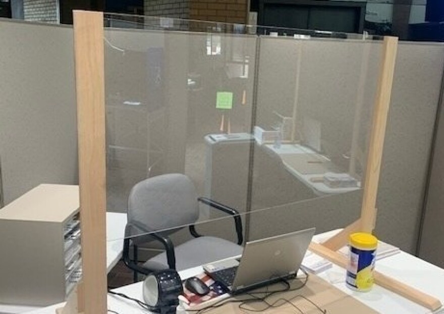 An improvised divider aims to protect voters and poll workers from the coronavirus.