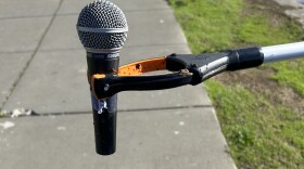 Trash Falcons pick up a microphone out of Lake Merritt using their grabbers.