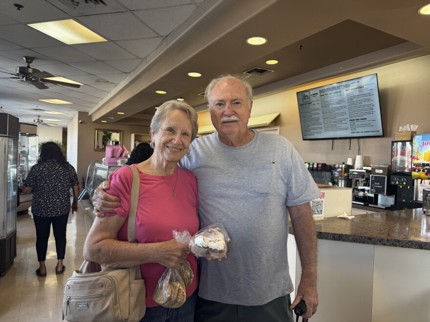 Joy Reed and her husband smile at the camera after making their last purchase at Goldsboro.