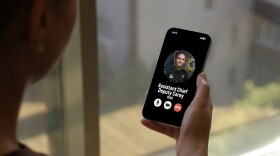 Person holds a phone with fake scam call from an assistant chief deputy 