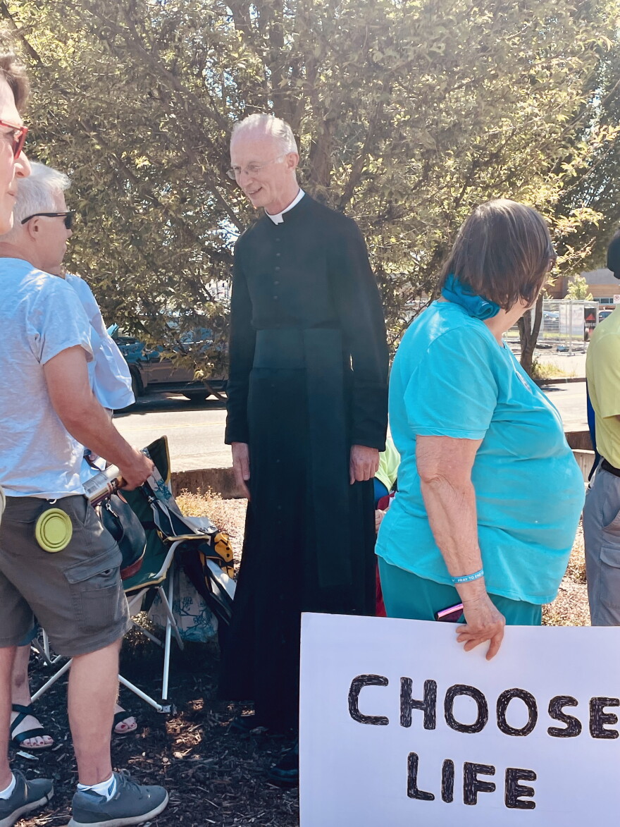 Father John Boyle read a prayer to the small crowd at a rally organized by Lane County Right to Life.