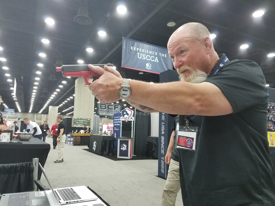 A vendor practices on virtual targets at the expo