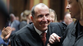 FILE - Michigan Supreme Court Justice Richard Bernstein is escorted to his seat before the State of the State address on Jan. 25, 2023, at the state Capitol in Lansing, Mich. Bernstein announced Tuesday, April 18, that he is getting mental-health treatment outside the state and will not hear a case next week. (AP Photo/Al Goldis, File)