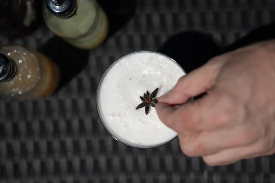 Brown places a star anise on top of the Spirit-Free Lion's Tail, an alcohol-free cocktail he just made.