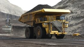 FILE - In this April 4, 2013, file photo, a mining dumper truck hauls coal at Cloud Peak Energy's Spring Creek strip mine near Decker, Mont. The Trump administration is considering using West Coast military bases or other federal properties as transit points for shipments of U.S. coal and natural gas to Asia. CREDIT: MATTHEW BROWN