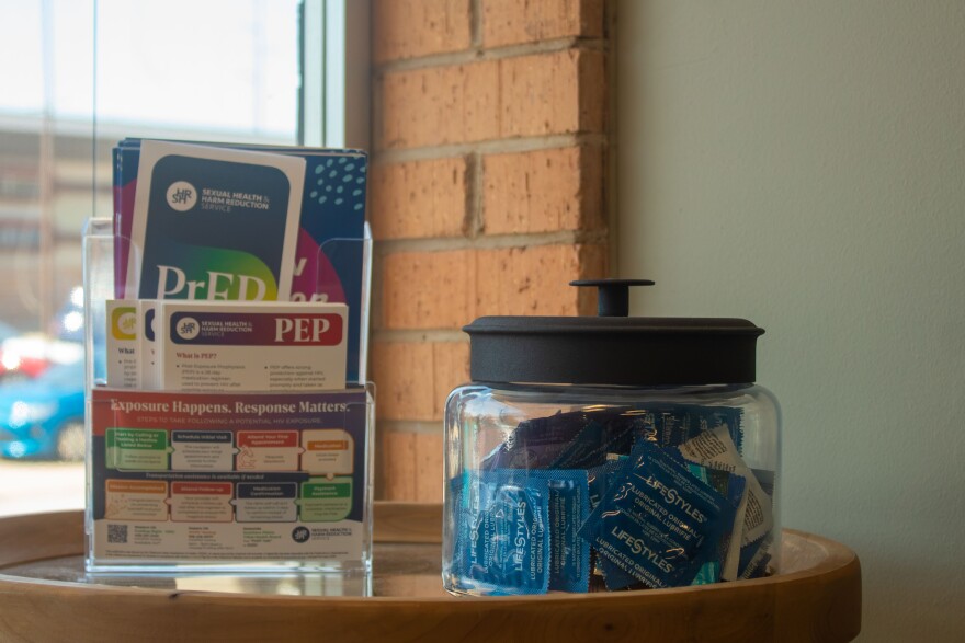 A jar of condoms and pamphlets for HIV prevention medication sits inside the waiting room of the New Hope Wellness Center, the clinical arm of Guiding Right. The public health nonprofit has received direct federal funding for decades, but now those dollars are being redirected to state health departments.