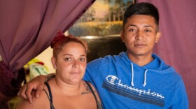 A wife and her husband are pictured in their home.